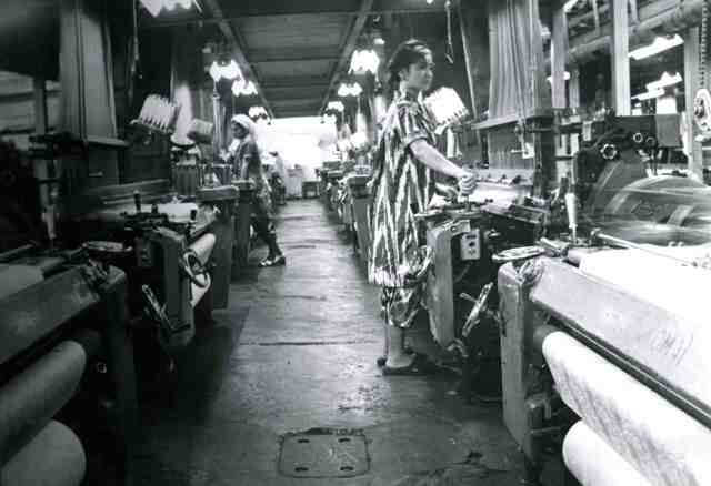 A woman weaving in a textile factory