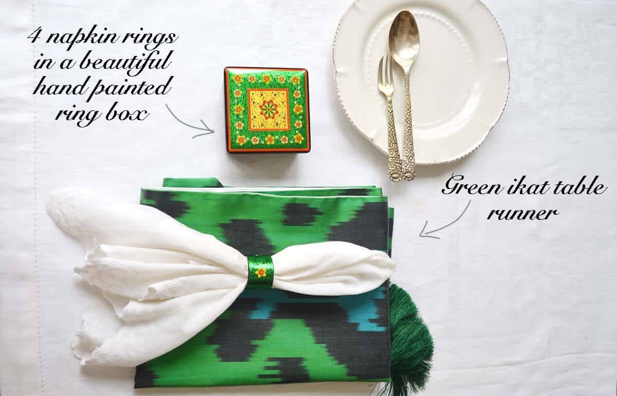 Washable green ikat table runner with napkin rings in a box