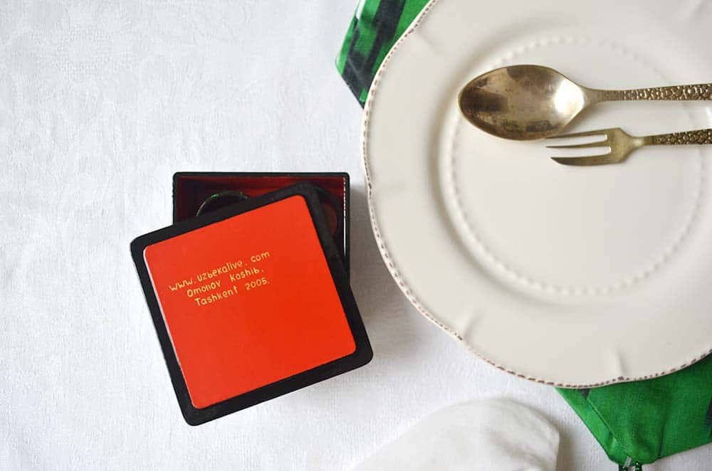 Inside artist's name napkin rings box with a plate
